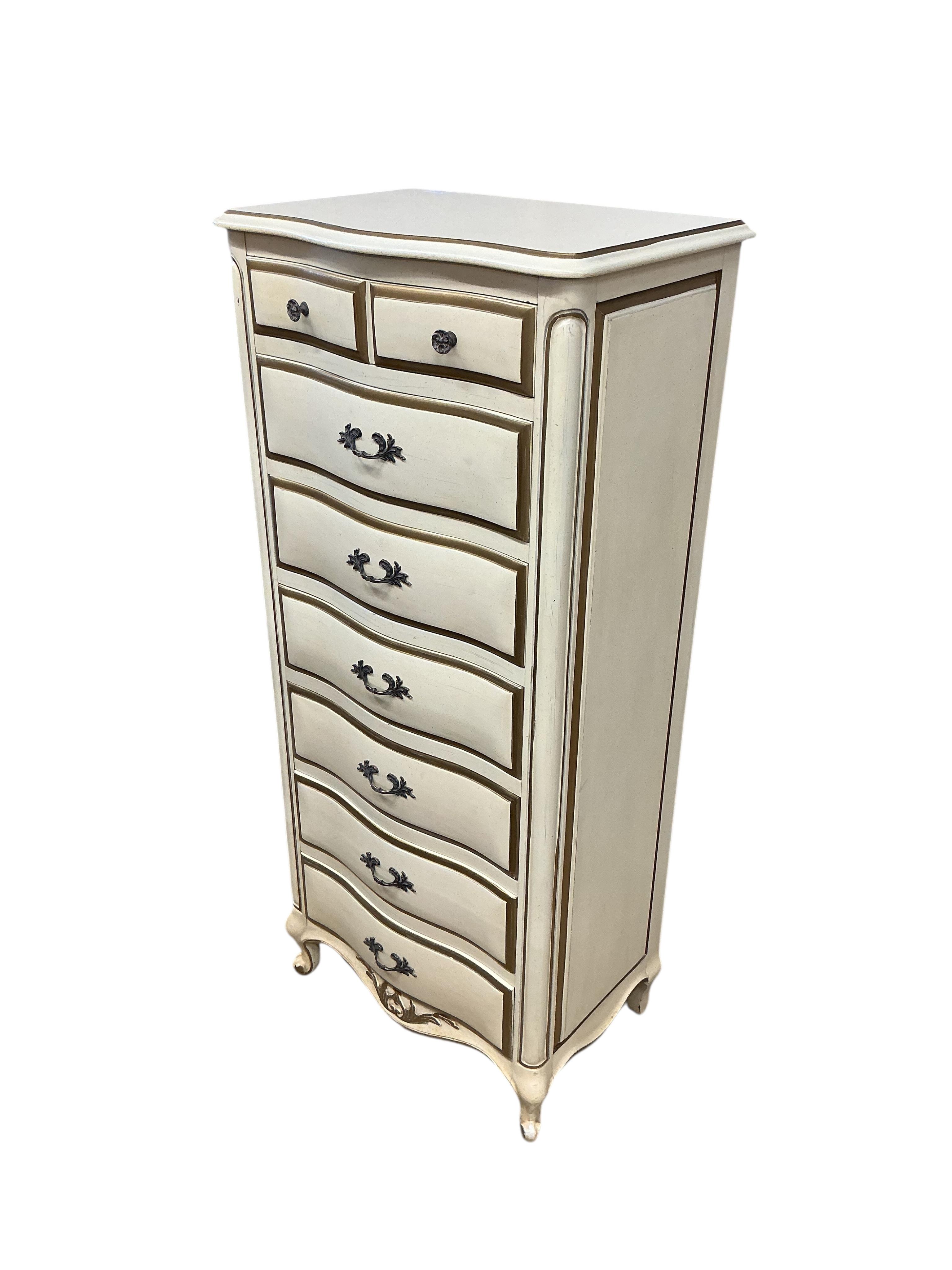An American cream and gilt painted narrow serpentine chest of drawers, width 60cm, depth 41cm, height 127cm